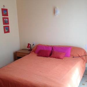 ラ・コティニエールにあるLocation Saint Pierre d'Oléronのベッドルーム1室(ピンクのシーツが備わる大型ベッド1台付)