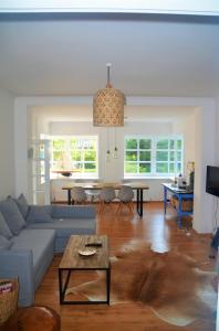 a living room with a couch and a table at Uns Landhus Tating in Tating