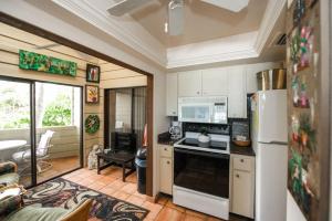 a kitchen with a refrigerator and a stove top oven at Fanta-Sea 47 by Beachside Management in Siesta Key