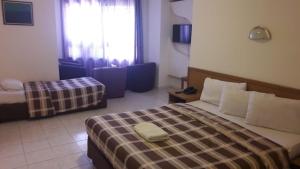 a hotel room with two beds and a window at Razan Hotel in Amman
