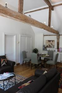 a living room with a couch and a table at High Street Farm Barn in Newbury