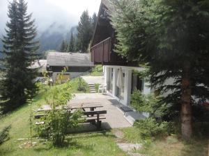 a house with a picnic bench in the grass at Wallisblick in Blatten bei Naters
