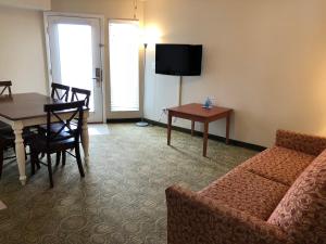 a living room with a couch and a table at Biscayne Family Resort in Wildwood Crest