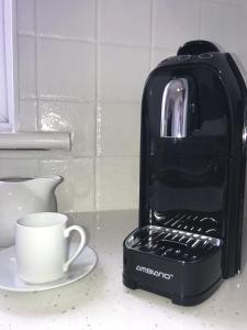 a toaster sitting on a counter next to a cup at The Links Cottage in Lahinch