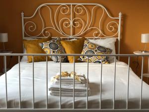 a bed with a metal bed frame and pillows at Etnante in Zafferana Etnea +30 photos