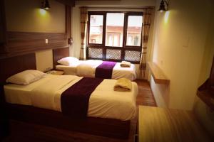 Postel nebo postele na pokoji v ubytování Kumari Guest House
