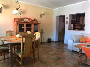 a dining room and living room with a table and a couch at Vista Mar in Trzęsacz