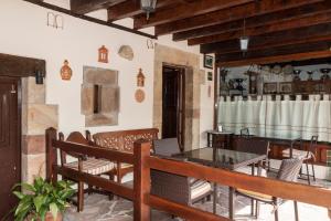 a patio with a table and chairs in a building at Posada La Bolera in San Vicente del Monte
