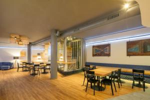 a dining room with wooden tables and chairs at Hotel Ostrov in Tisá