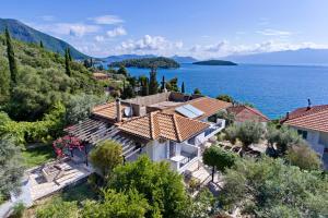 an aerial view of a house by the water at Korakias Skorpidi in Yénion