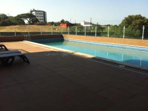 a swimming pool with a bench next to it at Sea view - top floor in Quarteira