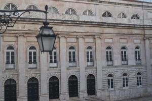 a building with a street light in front of it at Europe Lisboa Boutique Hotel in Lisbon