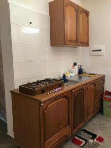 a kitchen with a stove and a counter top at Fati Guest House in Durrës