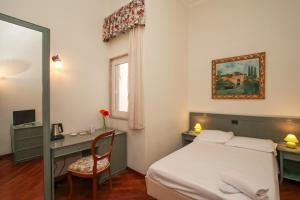 a bedroom with a bed, chair, mirror and a painting on the wall at Zodiacus Residence in Bari
