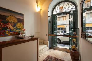 a hallway with a glass door leading to a living room at Zodiacus Residence in Bari