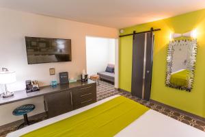 a hotel room with a yellow and green wall at University Inn ASU/Tempe in Tempe