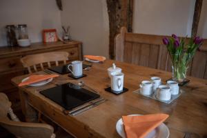 uma mesa de madeira com utensílios em cima em Old Beams Bed & Breakfast em Alcester