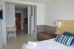 a small bedroom with a bed and a kitchen at Apartaments Gibert in Sant Antoni de Calonge