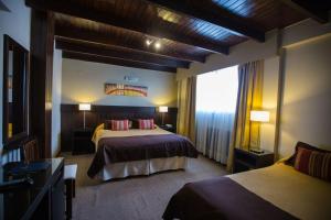 Кровать или кровати в номере Carlos V Patagonia