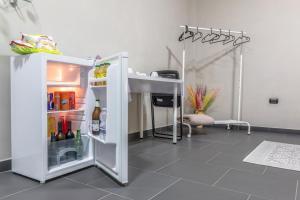 a refrigerator with its door open in a room at Tufaro B&B Private Room in Macerata Campania