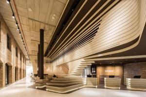 a lobby with a spiral staircase in a building at Radisson Collection Hotel, Old Mill Belgrade in Belgrade