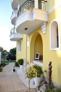 a yellow building with a balcony on the side of it at Boutique Villa Amalia in Chernomorets