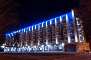 a building with blue lights on the side of it at Leningrad Hotel in Cherepovets