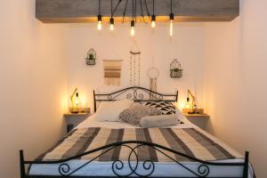 a bedroom with a bed with a black metal frame at Apartments Del Molo in Rijeka