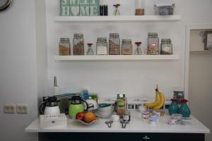 a kitchen with a counter with food items on it at De Langenlee in Zwolle