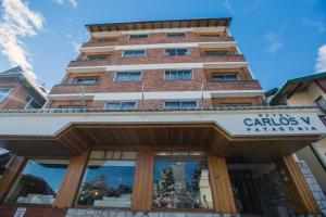 a tall building with a sign in front of it at Carlos V Patagonia in San Carlos de Bariloche