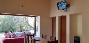 a living room with a couch and a table and a television at Canto a Jujuy in Yala