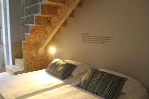 a bedroom with a bed with two pillows on it at StayInn City - Póvoa de Varzim in Póvoa de Varzim