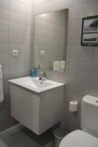 a bathroom with a sink and a mirror and a toilet at StayInn City - Póvoa de Varzim in Póvoa de Varzim