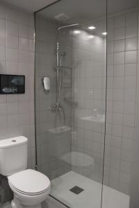 a bathroom with a glass shower with a toilet at StayInn City - Póvoa de Varzim in Póvoa de Varzim
