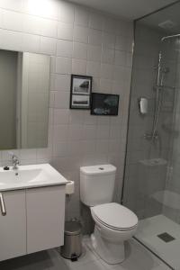 a bathroom with a toilet and a sink and a shower at StayInn City - Póvoa de Varzim in Póvoa de Varzim