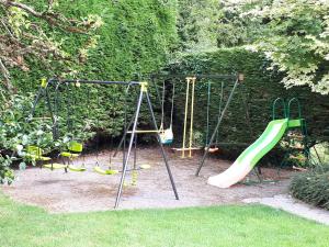 a playground with a swing set and a slide at Laurel Lodge in Shannonbridge