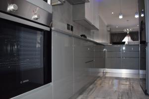 a kitchen with stainless steel appliances and a counter at Aya Luxury Apartment 84 in Durban