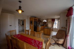 a kitchen and living room with a table and chairs at Pellipar Gatelodge in Bovevagh