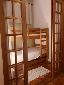 a small room with two bunk beds and a door at Solar Del Passo in Rio de Janeiro