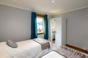 מיטה או מיטות בחדר ב-Lomond Serviced Apartments- Inglewood