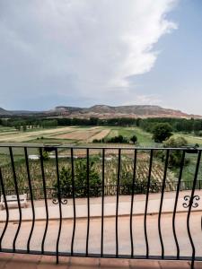 a iron fence with a view of a golf course at La Casa De La Vega in Teruel
