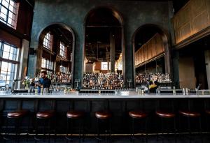 a group of people sitting at a bar at The Ramble Hotel in Denver