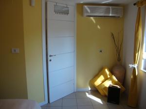 a room with a closet with a door and a fan at Apartments Ilona in Novi Vinodolski