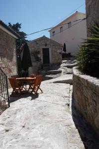 a patio with a table and umbrella and a building at Angelas - Casa da Galega in Vila Praia de Âncora