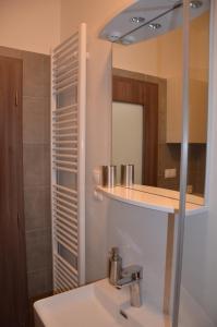 a bathroom with a sink and a mirror at Tatry Apartman, PRIMO, Starý Smokovec, Vysoké Tatry in Starý Smokovec +16 photos