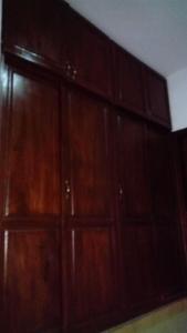 a room with wooden cabinets in a room at Appart TSINGA in Mokolo