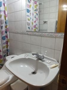 a bathroom with a sink, toilet, and bathtub at Windsor Suites Hotel in Santiago
