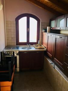 a small kitchen with a sink and a window at Drakulovic apartmani in Herceg-Novi