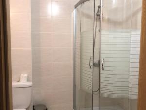 a bathroom with a glass shower with a toilet at Apartamenti Ely in Pomorie +48 photos