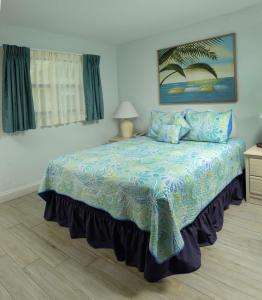 a bedroom with a blue and white striped bedspread at Tuckaway Shores Resort in Melbourne